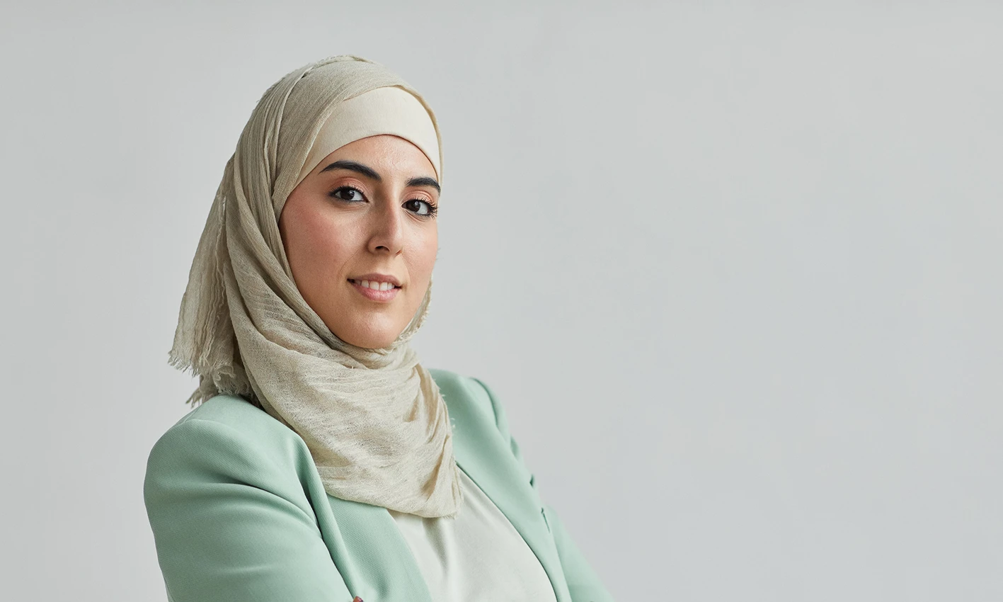 A woman wearing a crinkle scarf by Q&S Islamic Store.