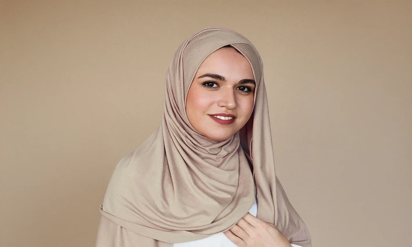 A woman wearing a jersey scarf by Q&S Islamic Store.