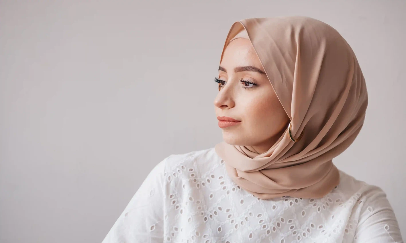 A woman wearing a jersey scarf by Q&S Islamic Store.