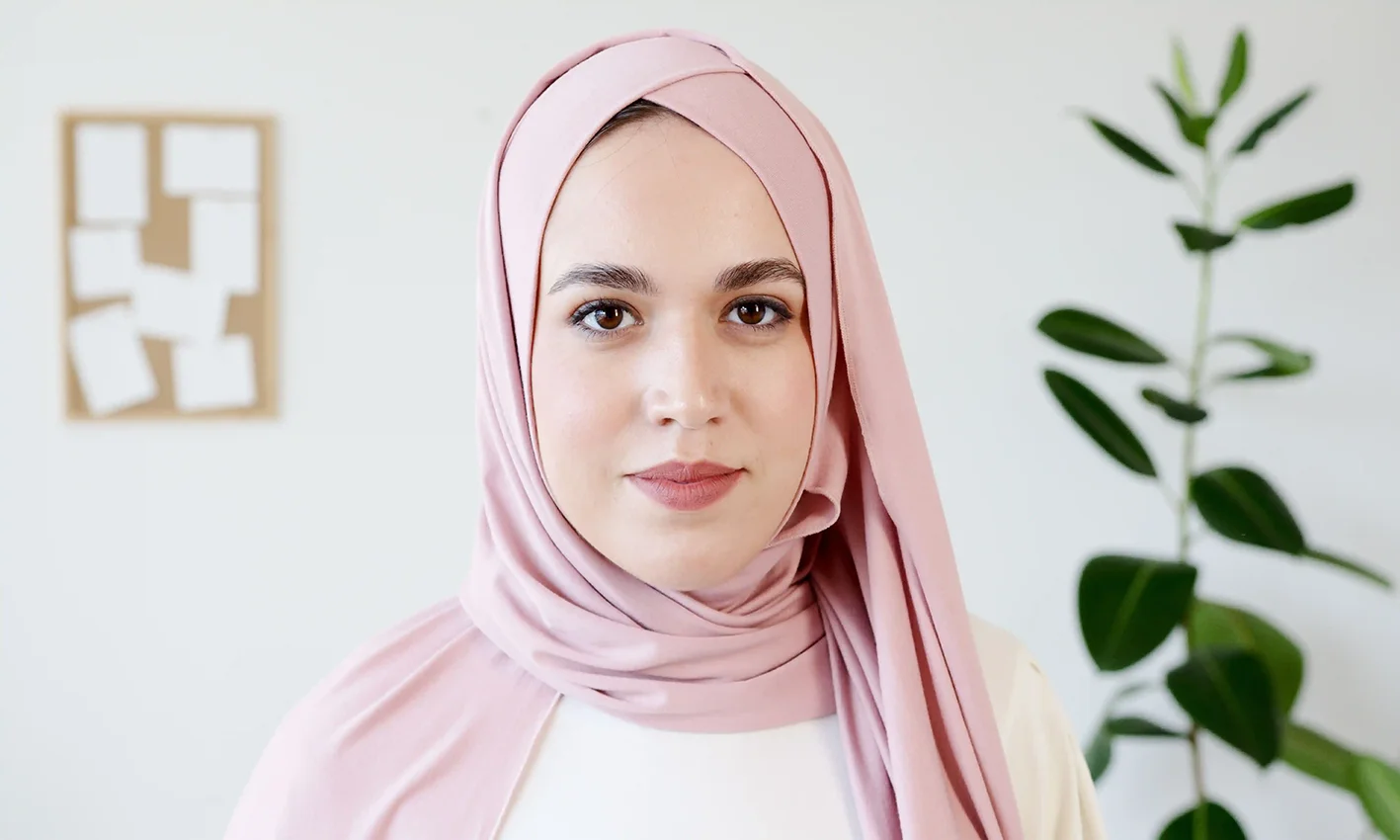 A woman wearing a jersey scarf by Q&S Islamic Store.